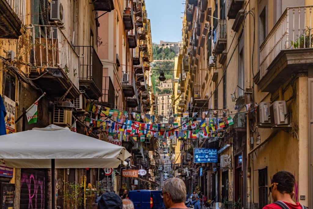 Rows of plastic flags flap in the breeze over the Spanish Quarter's narrow Via Forno Vecchio