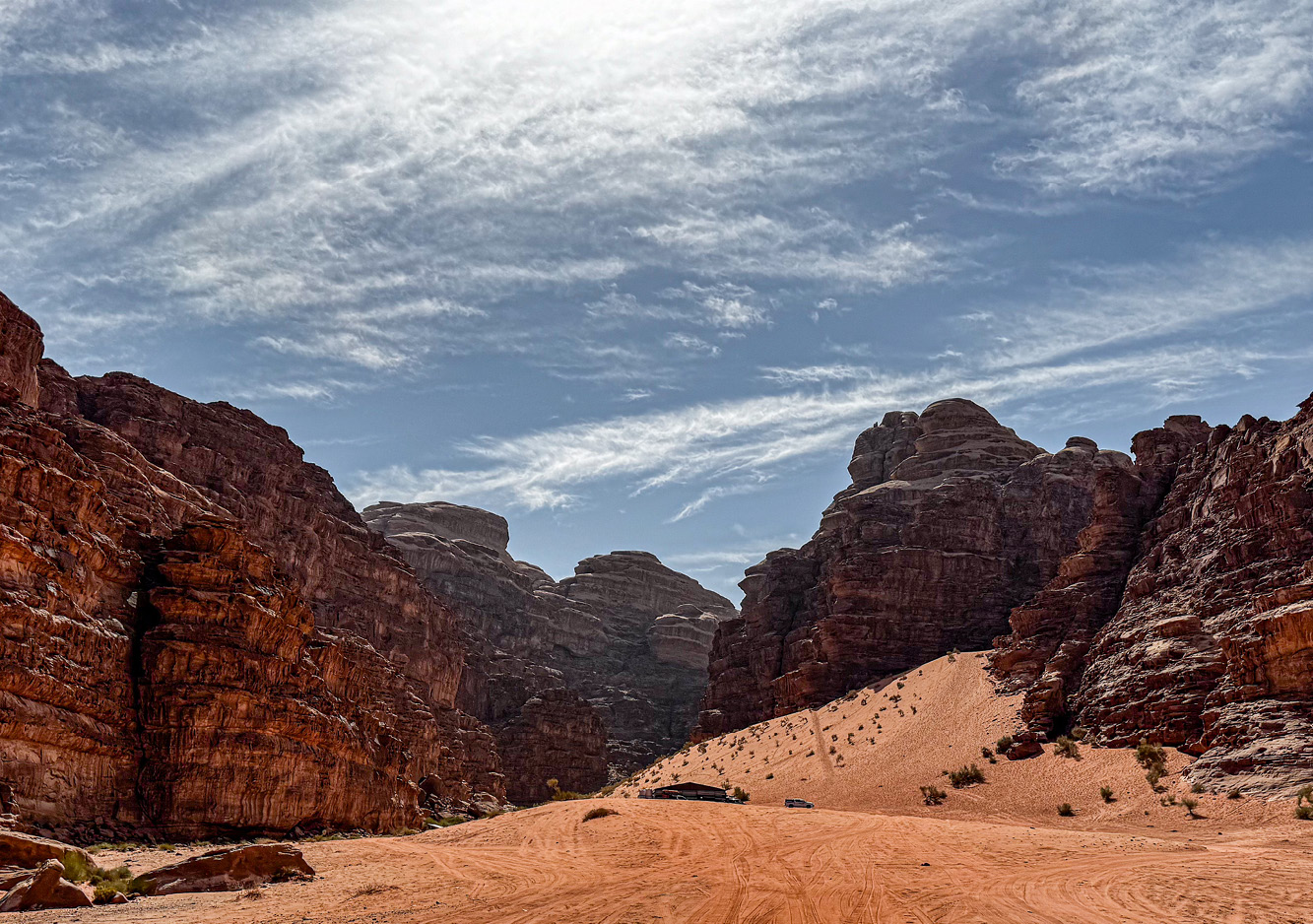 Stark landscape and vast desert of southern Jordan’s Wadi Rum Protected Area swallows tire tracks of local Bedouins who tour visitors staying in campsites tucked away among the sandstone and granite hills.