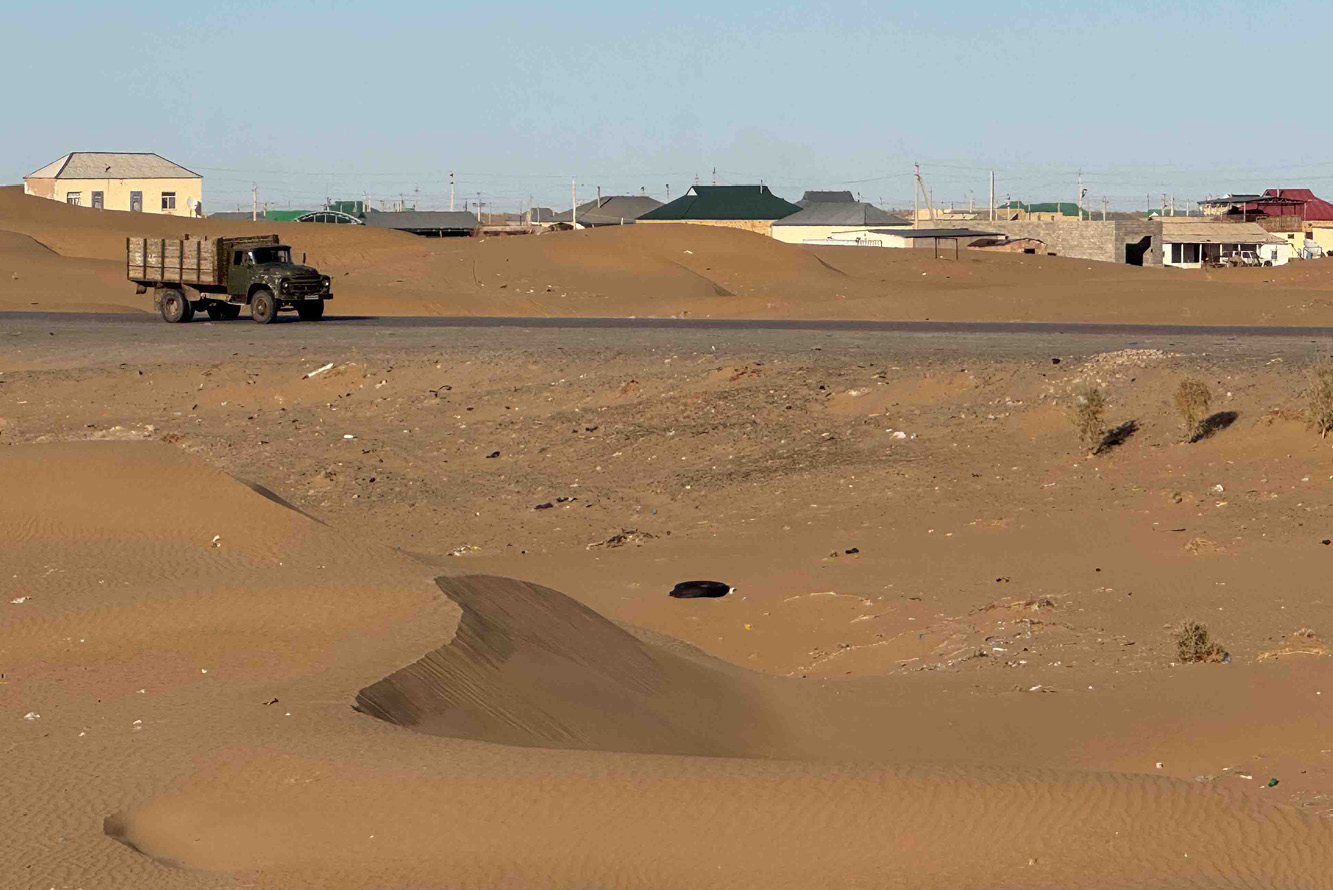 A single road winds among hills in Tian Shan Mountains