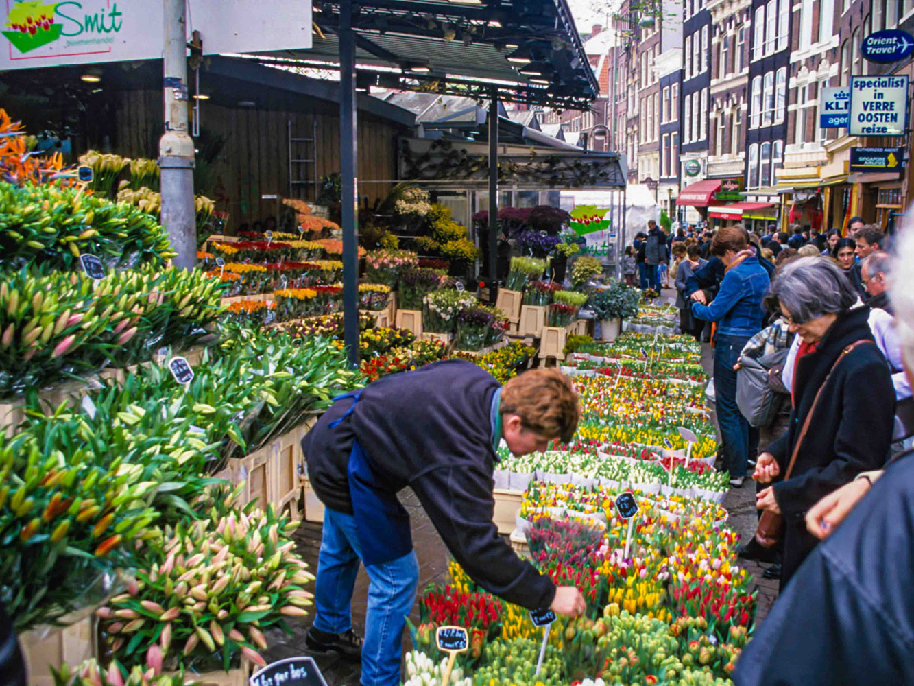 Customers crowd the daily flower market to buy spring bouquets