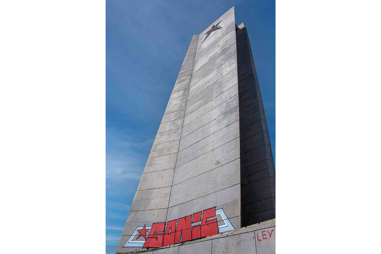 The outline of the Soviet red star tops the 250-foot obelisk